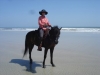 Sabine Dickel riding Bucksnorts Sweet Violet on the beach,